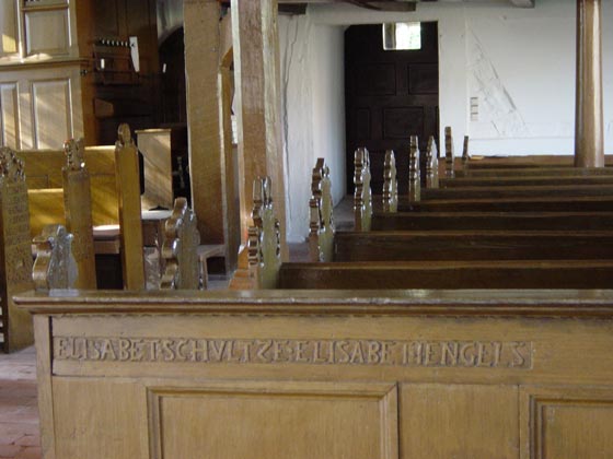 Picture of carved script on benches in Brunow church